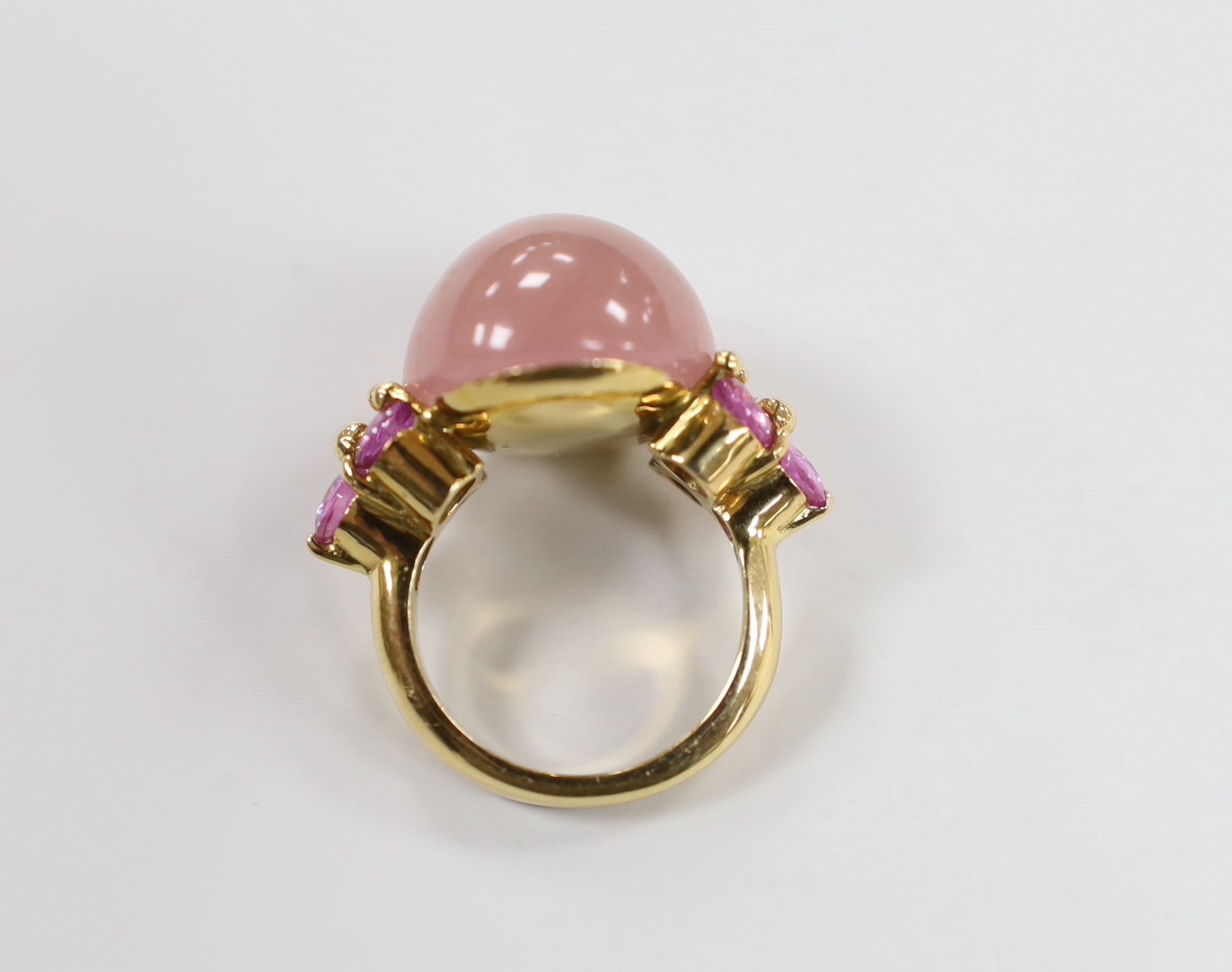 A modern 750 yellow metal, pink cabochon and six stone tourmaline> set dress ring, size M, gross weight 14.3 grams.